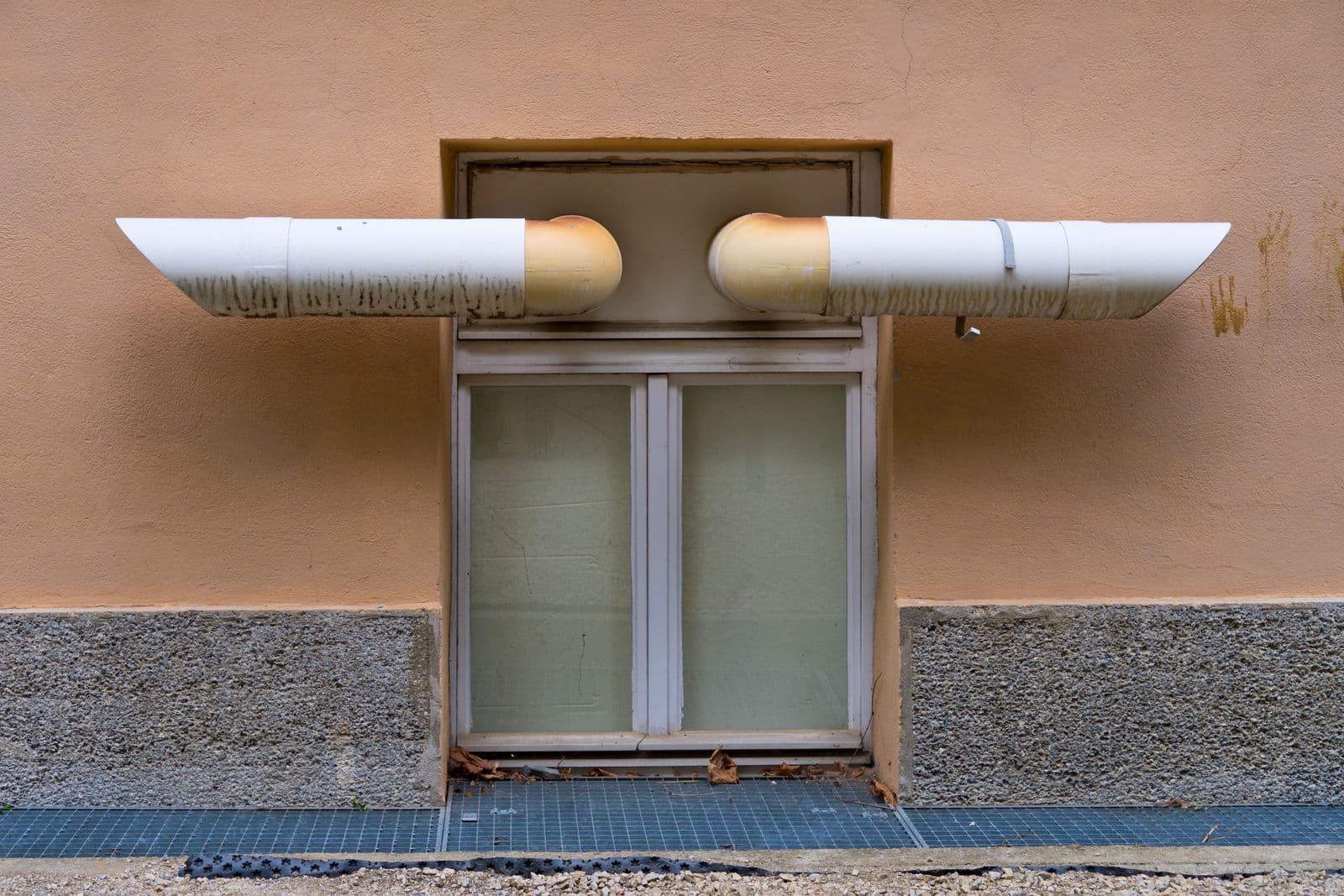 Ventilation pipes running along an exterior wall